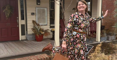 Woman poses in front of a building.