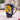 Navy blue mug with a yellow moon and crane design; sitting on a marble surface.