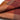 Close-up of a folded fabric with a checkered pattern in shades of brown and red.