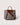 A structured gray felt tote bag with brown leather handles, a brown leather top panel, and a brown shoulder strap, shown on a light beige background.
