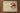 Placemat with lemon pattern on a wooden table with apples in a bowl.