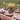 Garden Sunset Collection Tablecloth shown with dinnerware and floral accessory