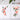 Two floral paintings on a gray surface with paintbrushes and color swatches.
