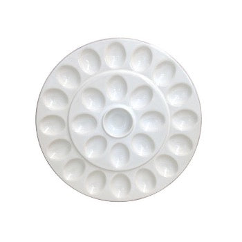 White ceramic plate with indents for deviled eggs.