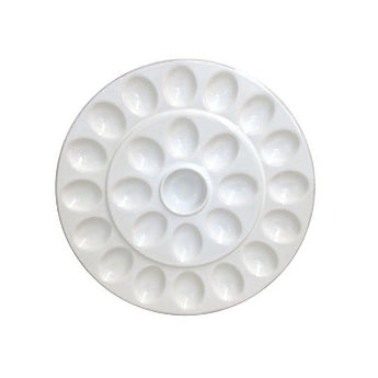 White ceramic plate with indents for deviled eggs.