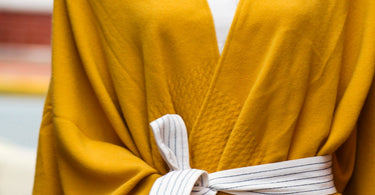 White dress with mustard yellow travel wrap from Mersea
