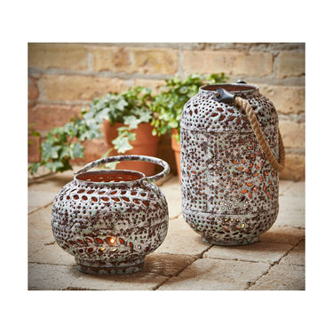 Sula Hand Pierced Iron Lantern Shown with candle and taller Lantern