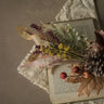 Dried flowers and leaves on an open book with a textured background