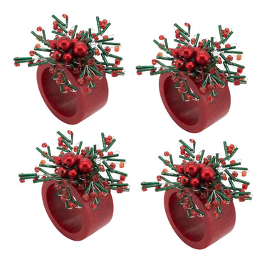 Four identical red cylindrical ring-shaped holders, each topped with a cluster of green pine-like branches, small red berries, and shiny red ornaments, arranged in a 2x2 grid on a white background.