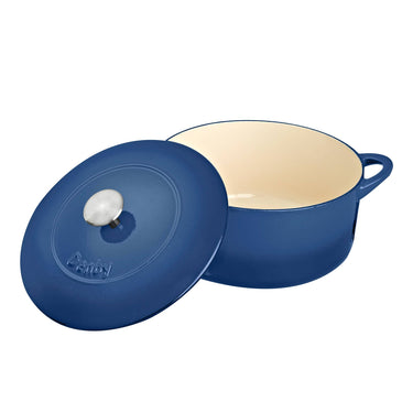 Blue cast iron cookware with beige interior on a white background