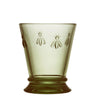 A green tumbler with a dragonfly pattern featuring bees and a sun design around the rim.