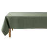 Green tablecloth on a wooden table with a white background