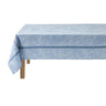 Light blue floral-patterned tablecloth on a wooden table with a white background