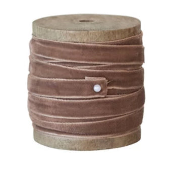 Wooden spool with walnut colored velvet ribbon secured with pin