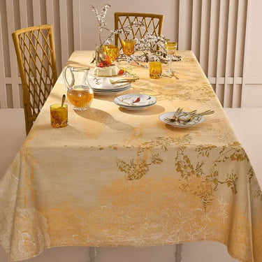 Dining table set with a floral tablecloth, glasses, and plates.