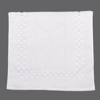 All White bath mat with check border design against gray background