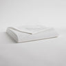 White folded set of sheets with one corner pulled back