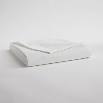 White folded set of sheets with one corner pulled back