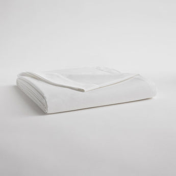 Folded white sateen sheets with top corner folded down