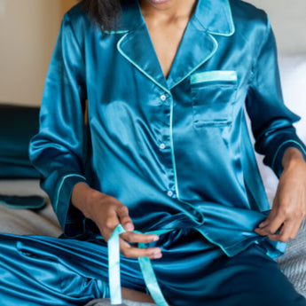 Model is wearing Satin Sailor Pajama set in Teal. The set has a contrasting piping in Aquamarine.