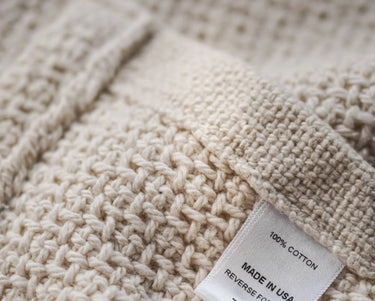 Close up of the Edgecomb bed blanket in Natural, showing texture of blanket.