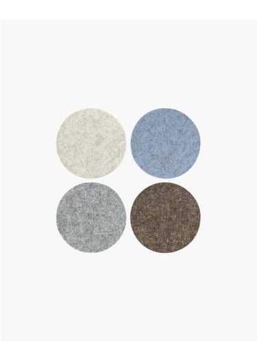 Four circular fabric swatches arranged in a 2x2 grid on a plain white background, showing textured material options in off-white, dusty blue, light gray, and dark brown.