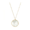 A gold chain necklace featuring a large circular pendant with a white mother-of-pearl inlay and a gold border, shown against a plain white background.