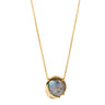 A gold chain necklace with a round bezel-set labradorite pendant and a small crescent moon accent, shown on a plain white background.