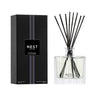Nest New York’s Cedar Leaf & Lavender Collection Diffuser featuring Nest’s signature etched glass diffuser bottle with black reeds. Packaging is black with purple stripe.