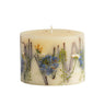 Rosy Rings Petite Botanical Candle shown in fragrance ‘Sea Salt Mist.’ Candle has pale blue, green and white dried flowers embedded in the wax.