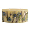 Rosy Rings Statement Botanical Candle shown in fragrance ‘Sea Salt Mist.’ Candle has light blue, white and green dried floral elements embedded within the wax.