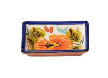 Small Terracotta Dipping Bowl by Casafina featuring an orange and yellow flower surrounded by green leaves against a white background with a blue border.  Underside is terracotta colored.