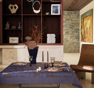 Sulawesi Blue Collection On set table. Tablecloth is a deep brown with electric blue floral center pattern, blue foliage border