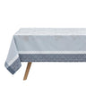 Manor Lane Blue Collection Tablecloth on table. Main area of tablecloth is light blue with a floral damask pattern. The border features a floral/geometric design in a lighter and darker blue.