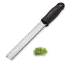 Microplane zester with a small pile of shredded green vegetable on a white background