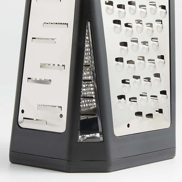 Multifunctional cheese grater with different blades on a white background