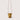 A mustard yellow canvas bucket bag with brown leather trim and a long brown shoulder strap, shown against a solid light beige background.