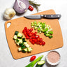 Totally Bamboo Vellum Composite Wood Fiber Cutting Board shown with chopped vegetables