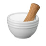 White mortar and wooden pestle on a white background