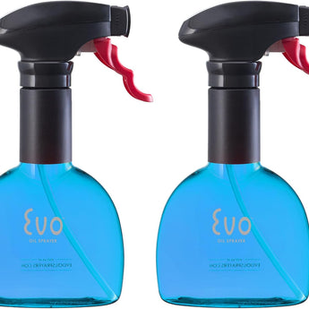 Set of 2 blue plastic oil sprayers with black heads and red ergonomic sprayer handles. Designed by Michael Graves.