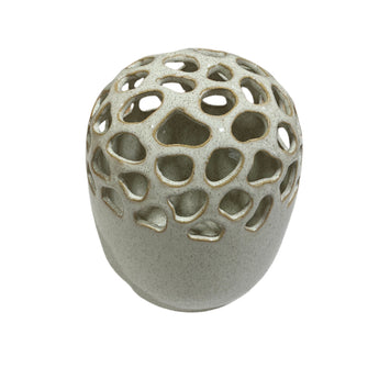 Cream colored stoneware vase with multi-hole opening at top for arranging flowers.