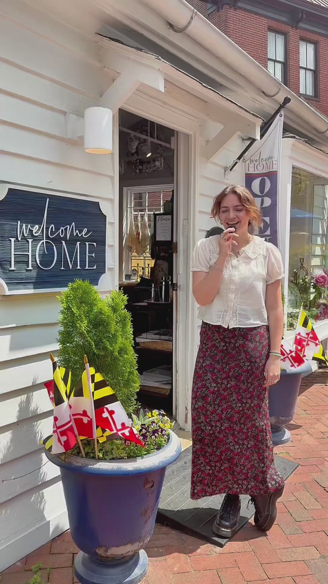Video of woman wearing a floral skirt and white blouse