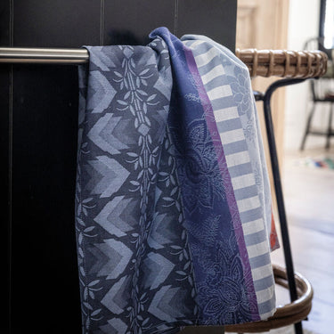 Patterned towel draped over a chair with a blurred indoor background