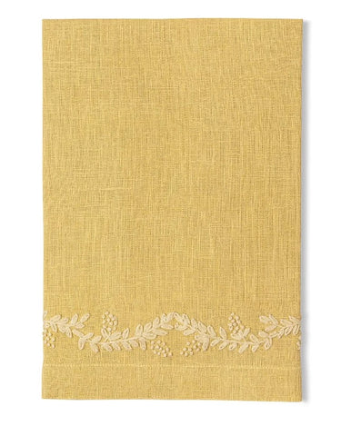Yellow linen napkin with floral vine embroidery